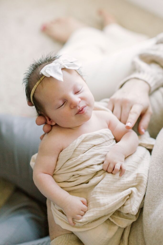 Peacefully sleeping newborn photographed for a newborn photography pricing guide by Lindsey Lambert Photography in Raleigh NC.