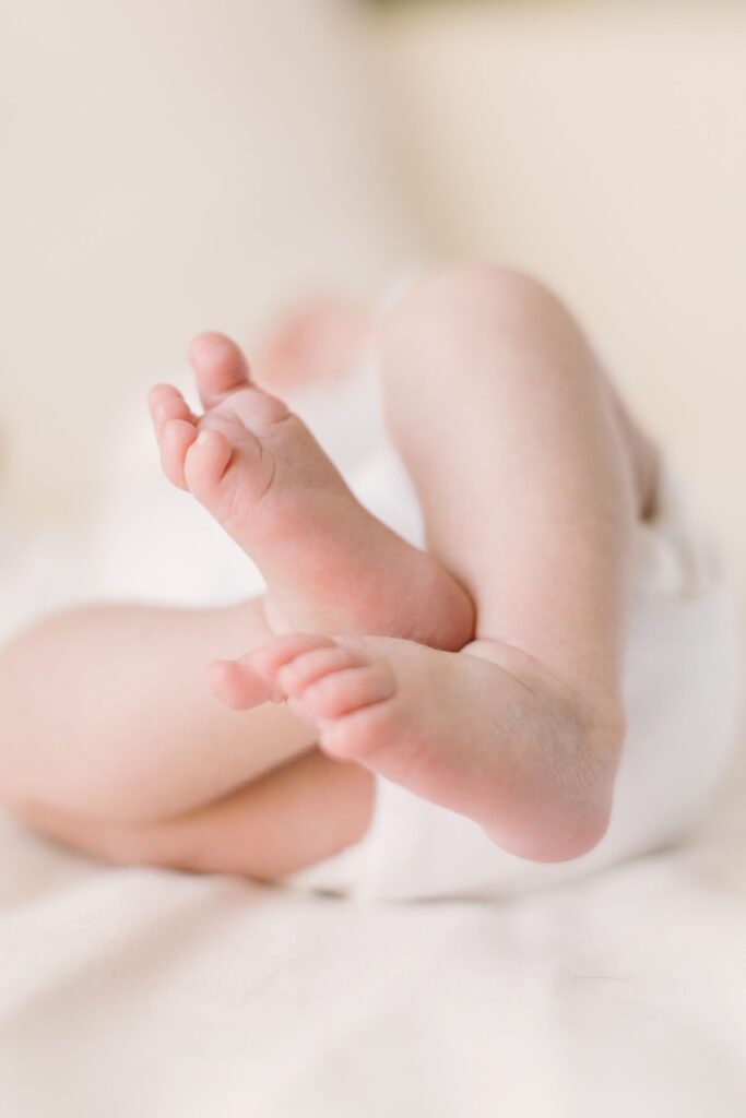 Close-up of tiny newborn feet highlighting the details families invest in when considering newborn photography cost in Raleigh NC.