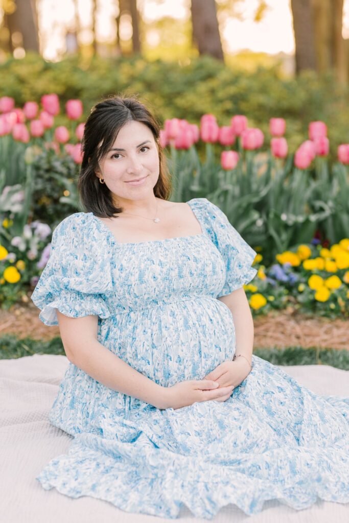 Expectant mother wearing a blue floral dress as an example of an outfit for maternity photos by Lindsey Lambert Photography in Raleigh NC.