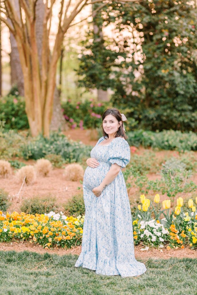 Outdoor maternity portrait showcasing what to wear to a maternity photoshoot in a Raleigh NC garden setting by Lindsey Lambert Photography.