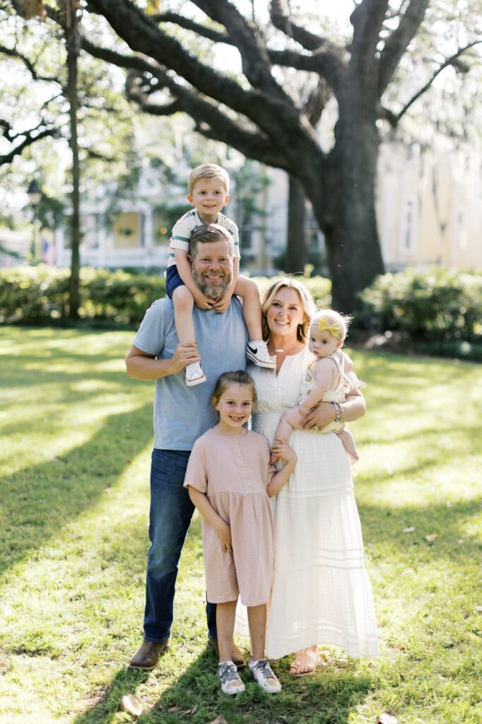 Family wearing neutral summer family photo outfits during an outdoor portrait session by Lindsey Lambert Photography in Raleigh NC.